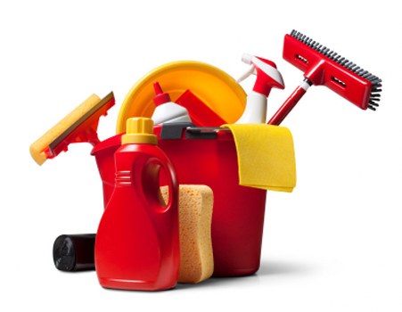 Professional cleaner sanitising desks in a Croydon office